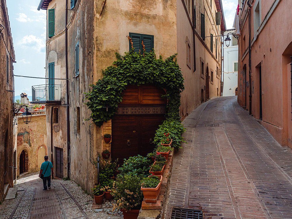 A person walking in the central streets of Trevi's old town at a fork, Trevi, Umbria, Italy, Europe