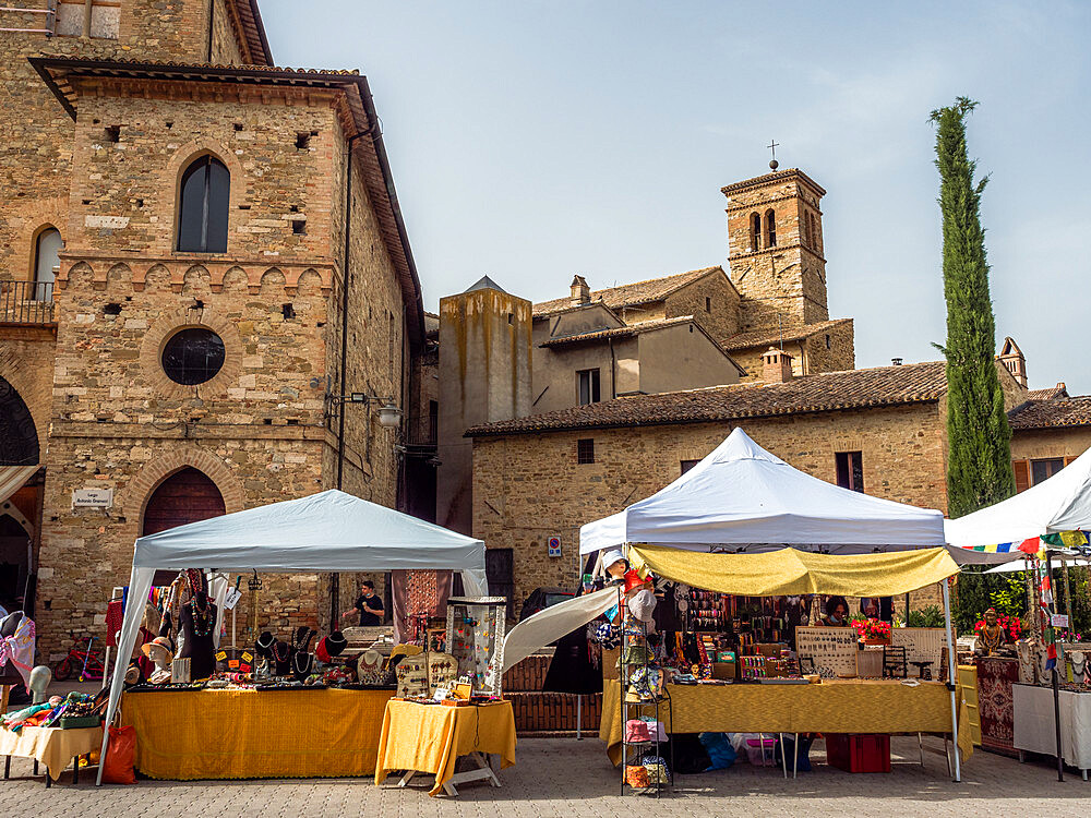 The street market of Bevagna's old town in the square behind Piazza Silvestri, with St. Silvestro's Church in the background, Bevagna, Umbria, Italy, Europe