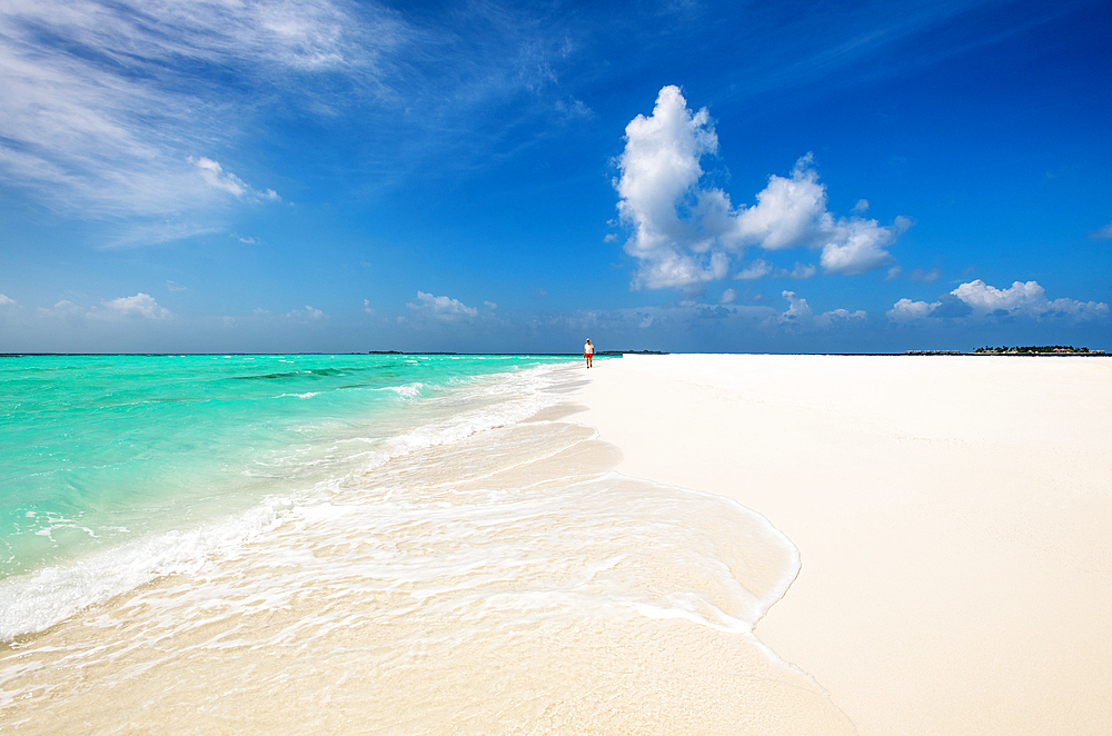 A man walking on a sanbank, Baa Atoll, Maldives