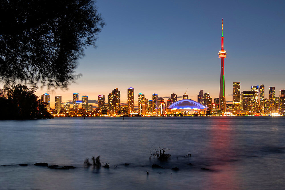 Toronto skyline featuring the CN Tower at night across Lake Ontario, from Toronto Islands Park, Toronto, Ontario, Canada, North America