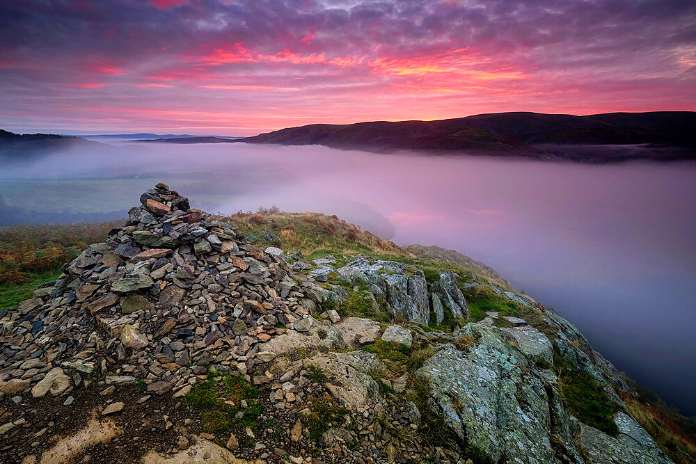 Summit Cairn on Yew Crag above misty Ullswater at sunrise, Gowbarrow Fell, Lake District National Park, UNESCO World Heritage Site, Cumbria, England, United Kingdom, Europe