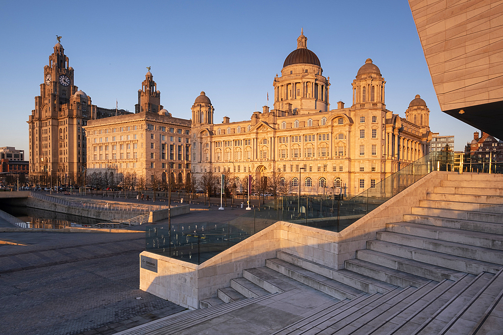 Evening light illuminates the Liver Building, the Cunard Building and Port of Liverpool Building (The Three Graces), Pier Head, Liverpool Waterfront, Liverpool, Merseyside, England, United Kingdom, Europe