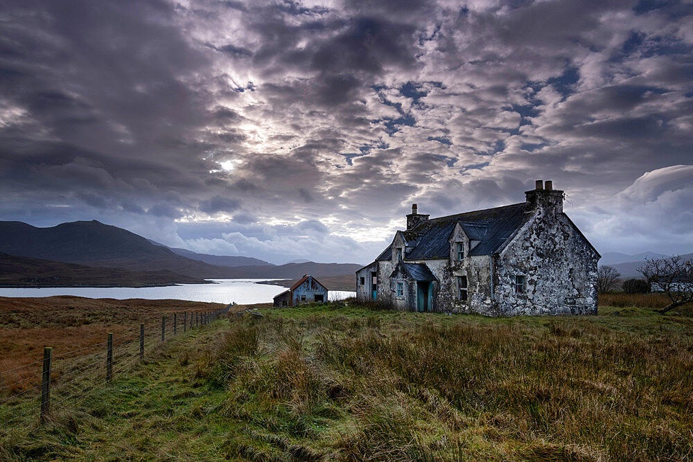 Abandoned Croft House overlooking Loch Siophort and the Harris Hills, Arivruaich, Isle of Lewis, Outer Hebrides, Scotland, United Kingdom, Europe