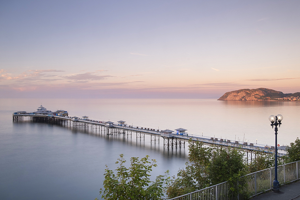 Llandudno Pier and the Little Orme from the Promenade at sunset, Llandudno, Conwy County Borough, North Wales, UK