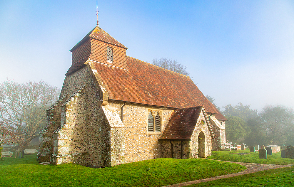 The 11th century Church of St. Mary The Virgin on a foggy winter morning, Friston, South Downs National Park, East Sussex, England, United Kingdom, Europe