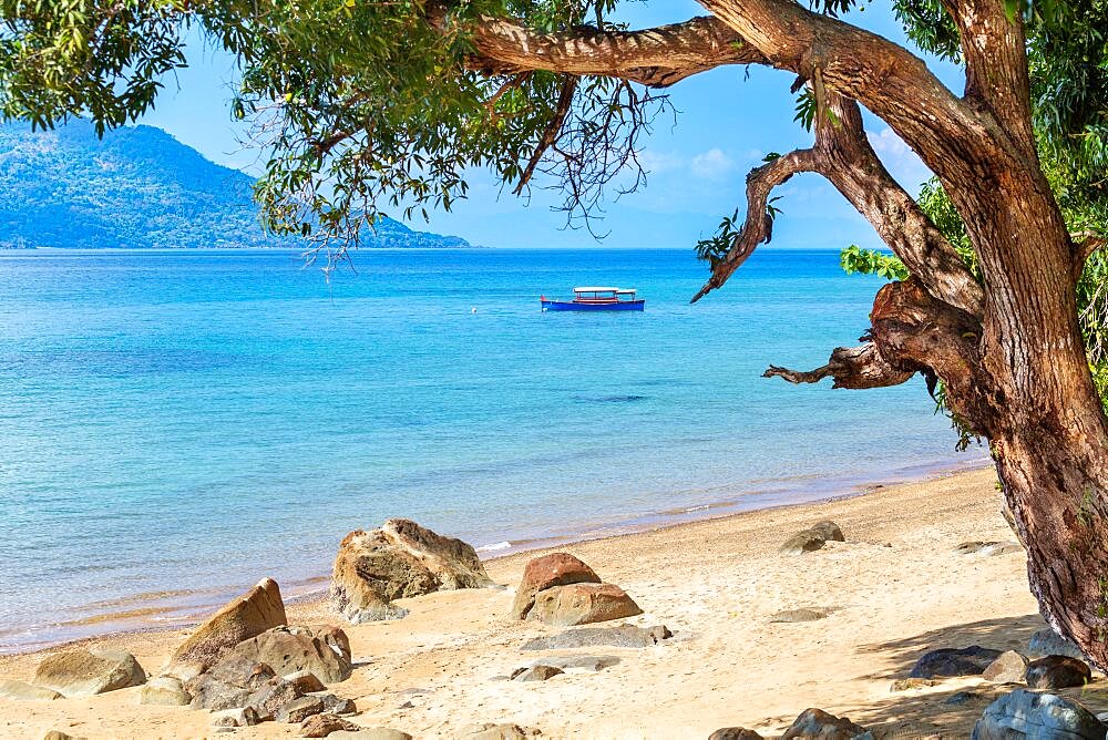 Boat anchored off the beach at Nosy Komba island, North West Madagascar.