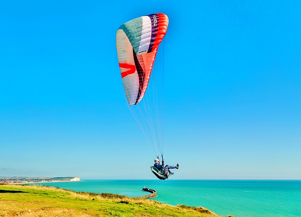 Paraglider taking off above the harbour at Newhaven, East Sussex. England, United Kingdom, Europe