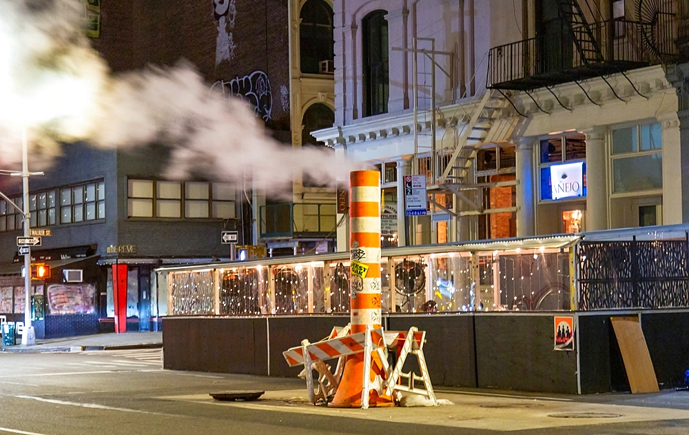 Steam emitted from the New York Steam System. Dating back to 1882 the system provides steam to heat, cool or disinfect some 1,700 buildings. Excess steam is vented from orange and white funnels known as stacks.