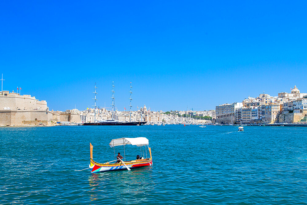 Traditional ferry boat crossing the Grand Harbour, with the Maltese Falcon superyacht in the background, Valletta, Malta, Mediterranean, Europe