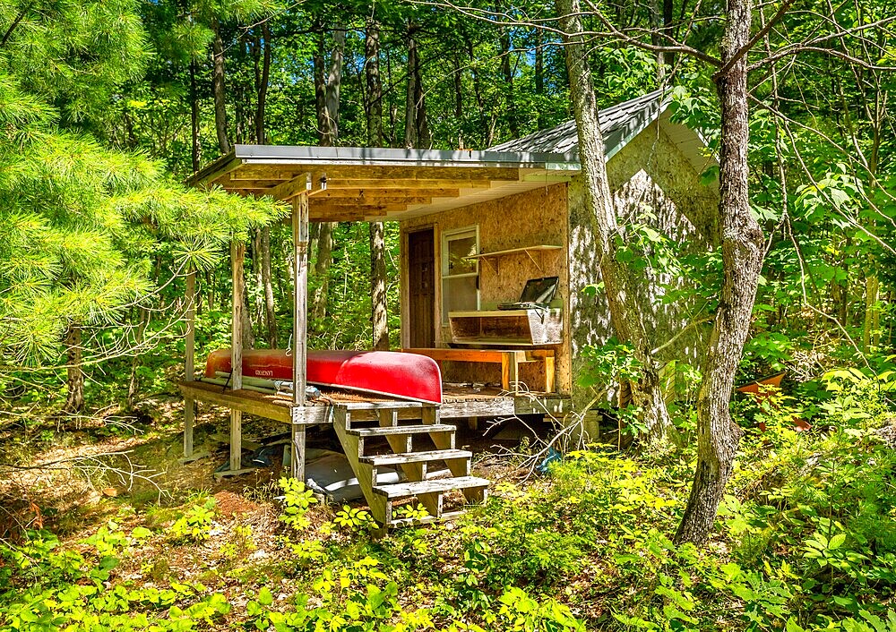 Red canoe in a cottage outbuilding, Francis Island, Georgian Bay, Ontario, Canada.
