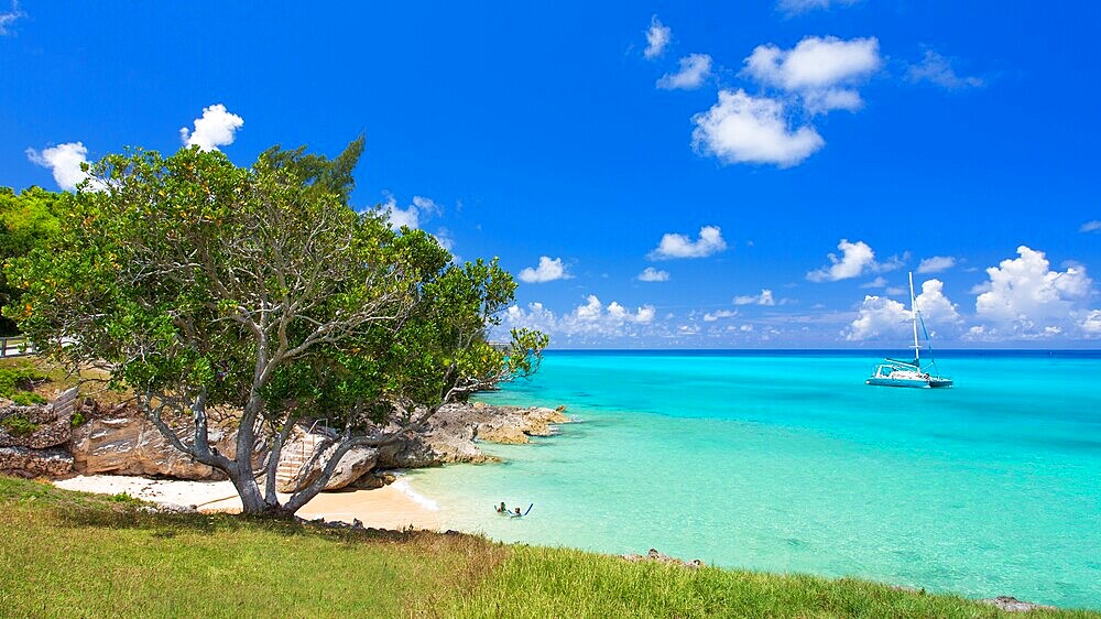 Catamaran passing Drew's Bay, St George's, Bermuda. A secluded and sandy beach at the historic East end of the island.