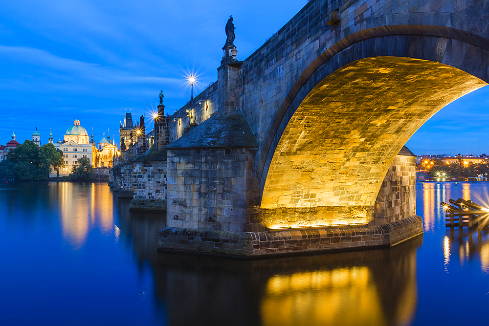 Illuminated arch of Charles Bridge at twilight, UNESCO World Heritage Site, Prague, Czechia, Europe