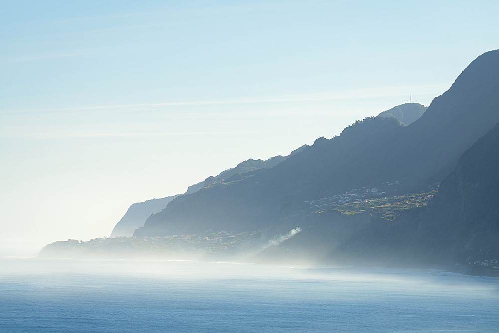 Distant view of sea coast and towns of Sao Vicente and Ponta Delgada on misty morning, Madeira, Portugal, Atlantic, Europe