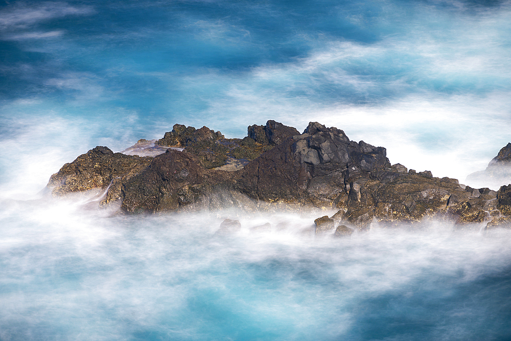 Aerial view of small rock island amongst waves, Madeira, Portugal, Atlantic, Europe