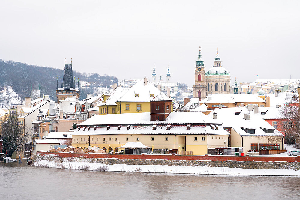 Lesser Quarter of Prague dominated by St. Nicolas church with snow in winter, UNESCO, Prague, Czech Republic