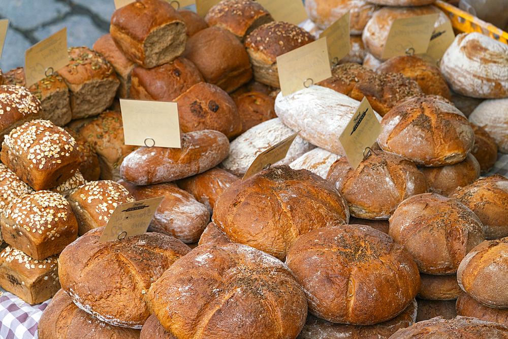 Different types of fresh bread on display at farmers market on Vltava riverside near Palackeho namesti, Prague, Czech Republic (Czechia), Europe