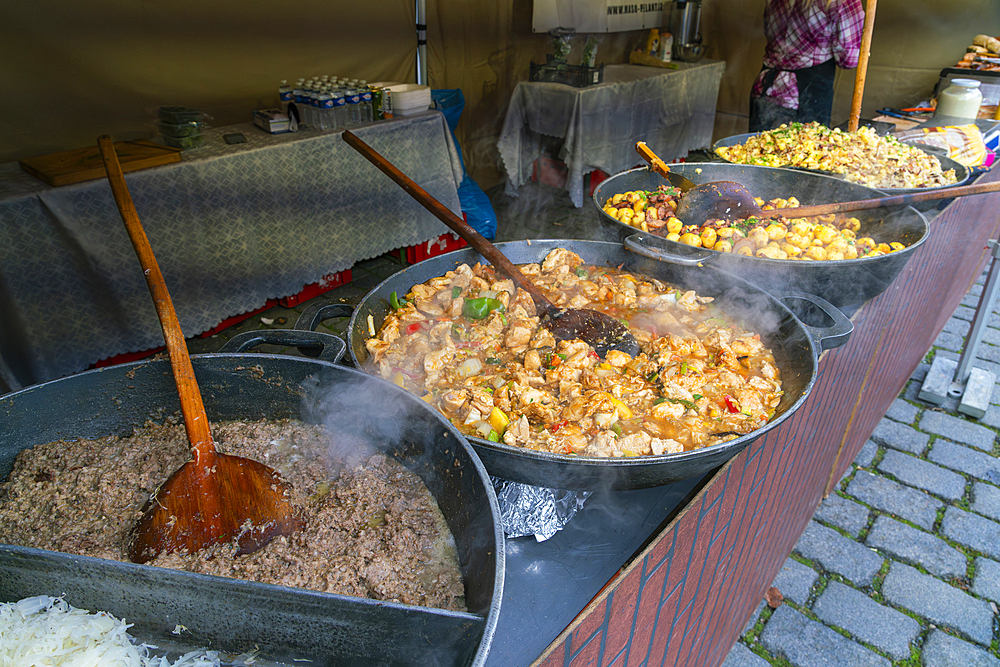 Different types of meals in big saucepans on display at farmers market on Vltava riverside near Palackeho namesti, Prague, Czech Republic (Czechia), Europe