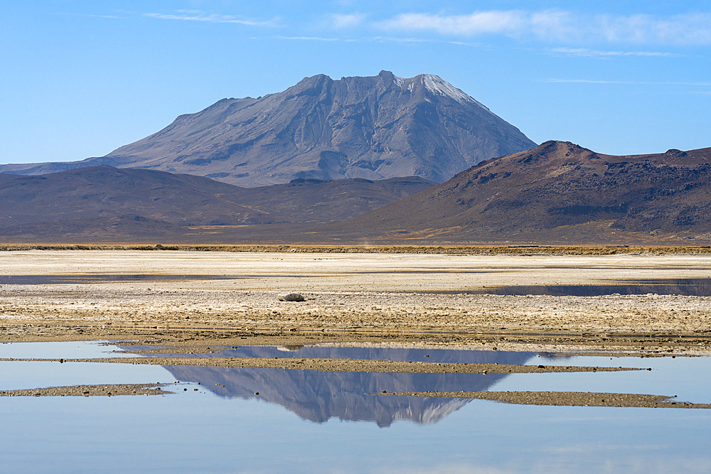 Ubinas volcano reflected in a pool at salt flats, Salinas y Aguada Blanca National Reserve, Arequipa Province, Arequipa Region, Peru, South America