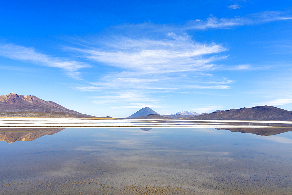 Reflection pool on salt flats and distant views of El Misti and Chachani volcanoes, Salinas y Aguada Blanca National Reserve, Arequipa Province, Arequipa Region, Peru, South America