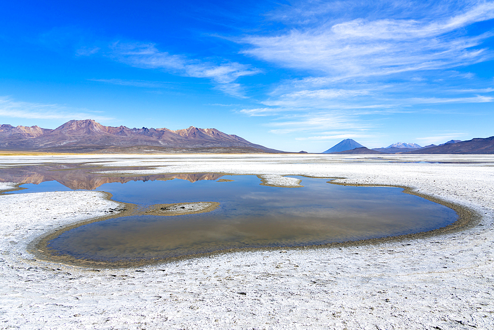 Reflection pool on salt flats and distant views of Pichu Pichu, El Misti and Chachani volcanoes, Salinas y Aguada Blanca National Reserve, Arequipa Province, Arequipa Region, Peru, South America