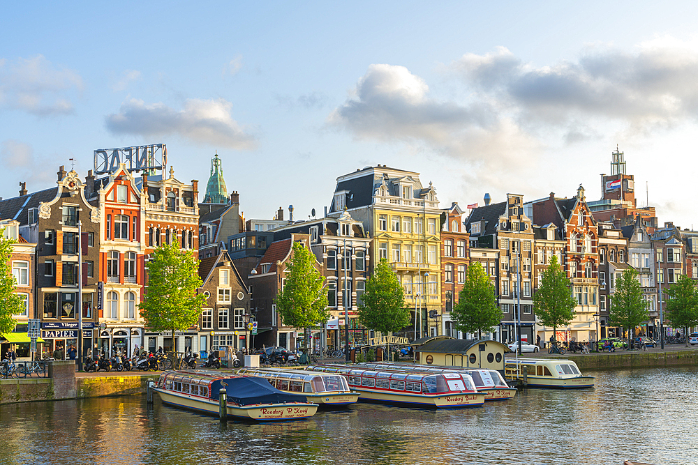 Boats on Amstel River at sunset, Amsterdam, The Netherlands, Europe