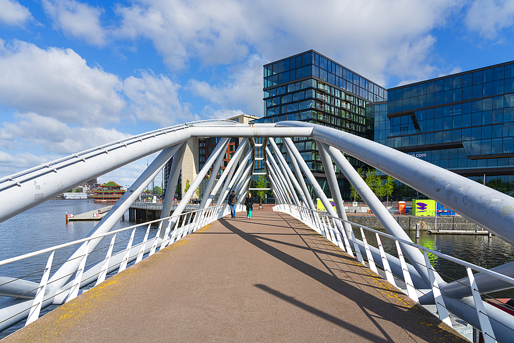 Man and woman walking on Mr. J.J. van der Veldebrug bridge, Amsterdam, The Netherlands, Europe