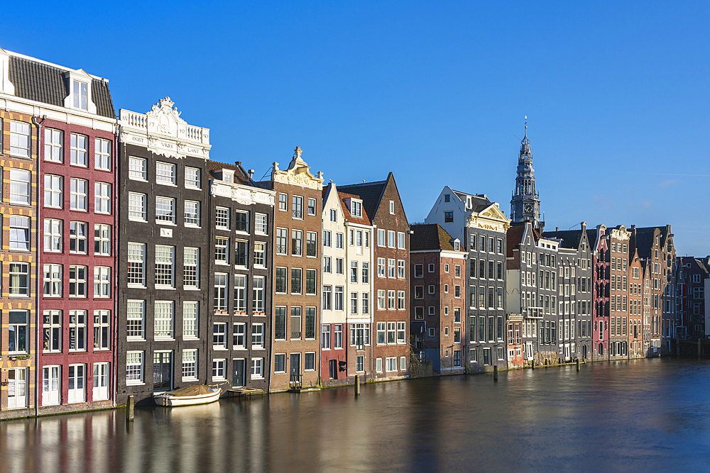 Dancing houses at Damrak and tower of Oude Kerk Amsterdam Church, Amsterdam, The Netherlands, Europe