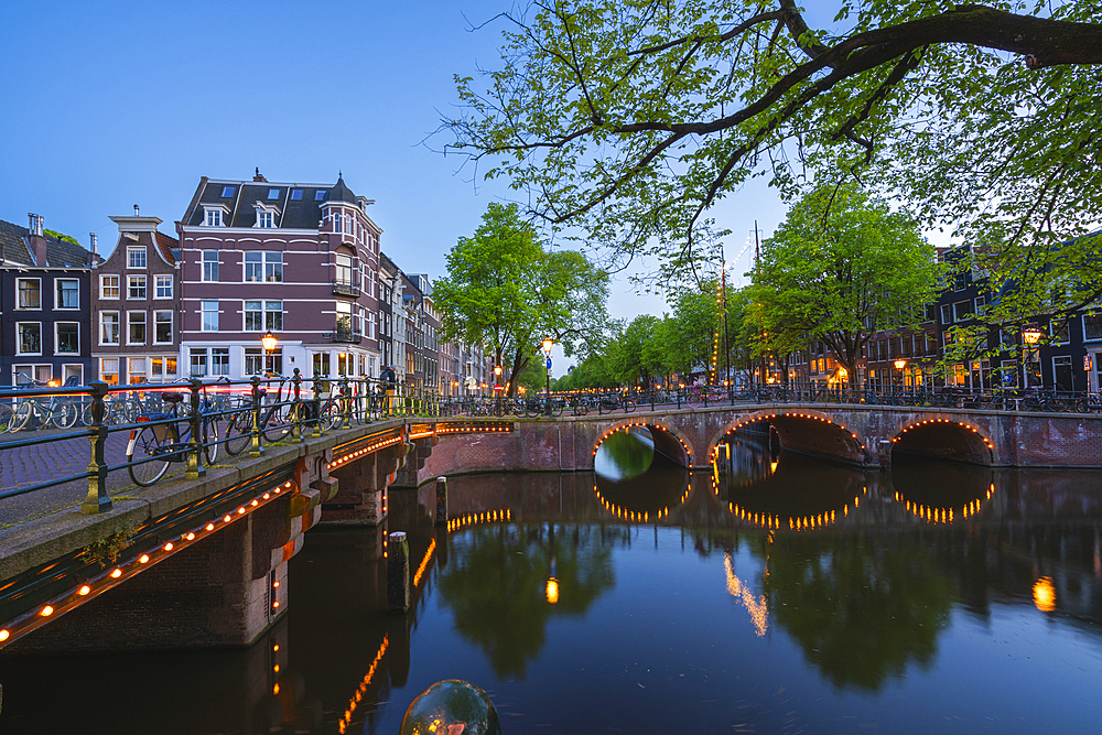 Illuminated bridge over Brouwersgracht canal at twilight, Amsterdam, The Netherlands, Europe