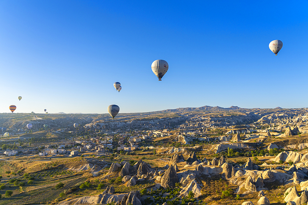 Aerial view of hot air balloons over rock formations at sunrise, Goreme, Goreme Historical National Park, UNESCO World Heritage Site, Cappadocia, Central Anatolia Region, Anatolia, Turkey, Asia Minor, Asia