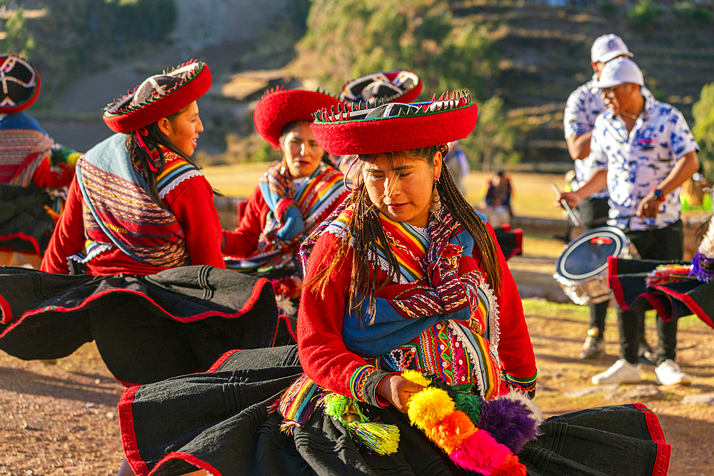 Peruvian women in traditional dresses dancing on celebration, Chinchero, Peru, South America