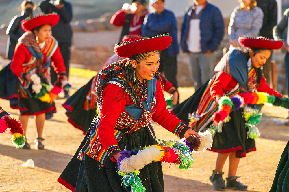 Peruvian women in traditional dresses dancing on celebration, Chinchero, Peru, South America