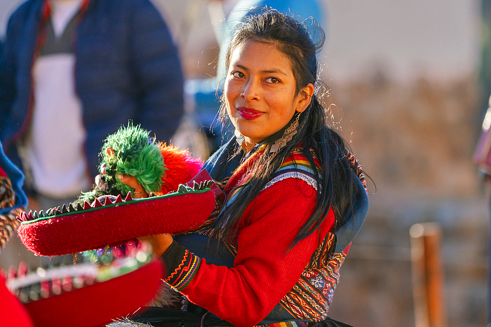 Peruvian woman in traditional dress dancing on celebration, Chinchero, Peru, South America