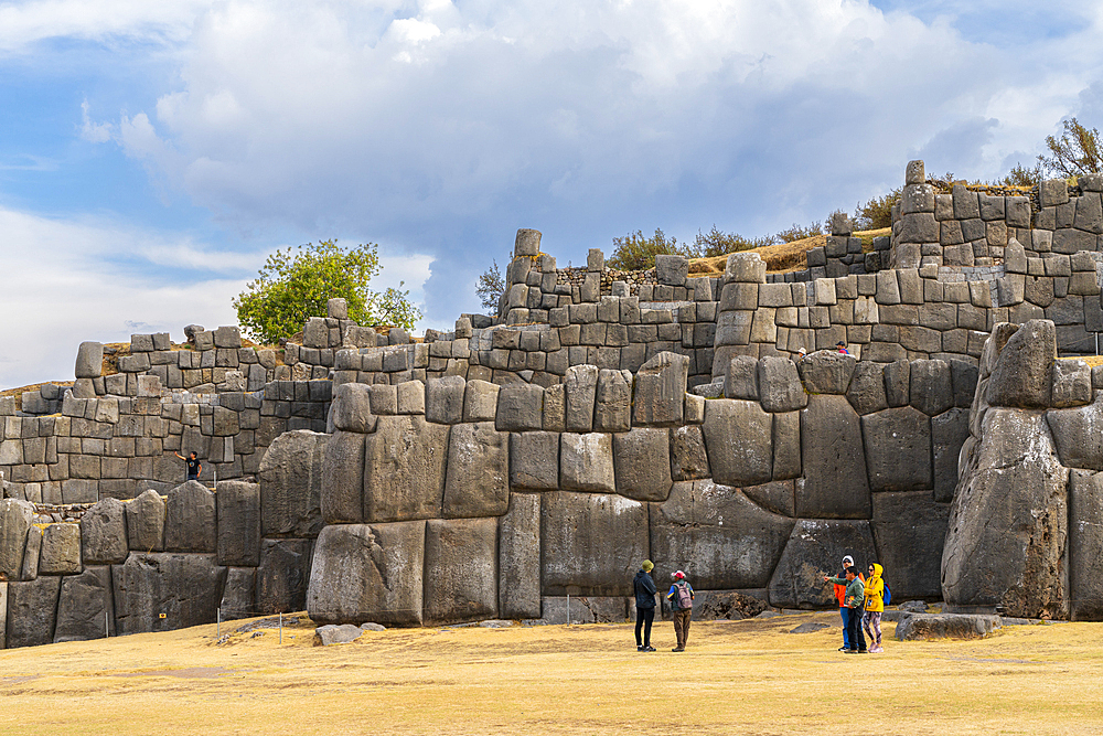 Tourists at stone wall at archaeological site of Sacsayhuaman, UNESCO World Heritage Site, Cusco, Cusco Region, Peru, South America