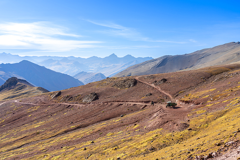 Motocycle and tuk tuk on mountain road in Andean mountains near Rainbow mountain, Pitumarca District, Cuzco Region, Peru