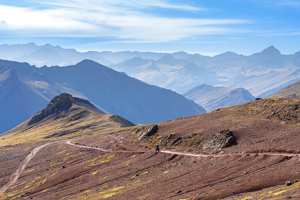 Motocycle on mountain road in Andean mountains near Rainbow mountain, Pitumarca District, Cuzco Region, Peru