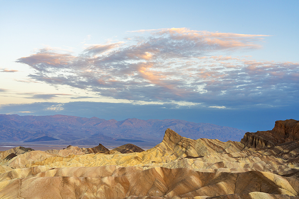 Natural rock formations with Manly Beacon at Zabriskie Point at sunrise, Death Valley National Park, Eastern California, California, United States of America, North America