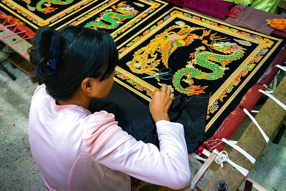 Woman embroidering ornaments at workshop, Mandalay, Myanmar