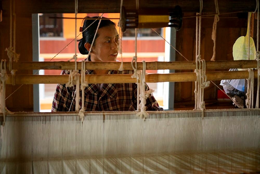 Burmese woman working on loom at workshop, Lake Inle, Myanmar