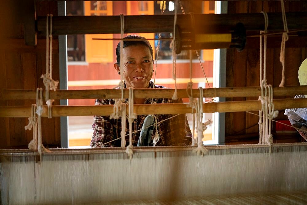 Burmese woman working on loom at workshop, Lake Inle, Myanmar