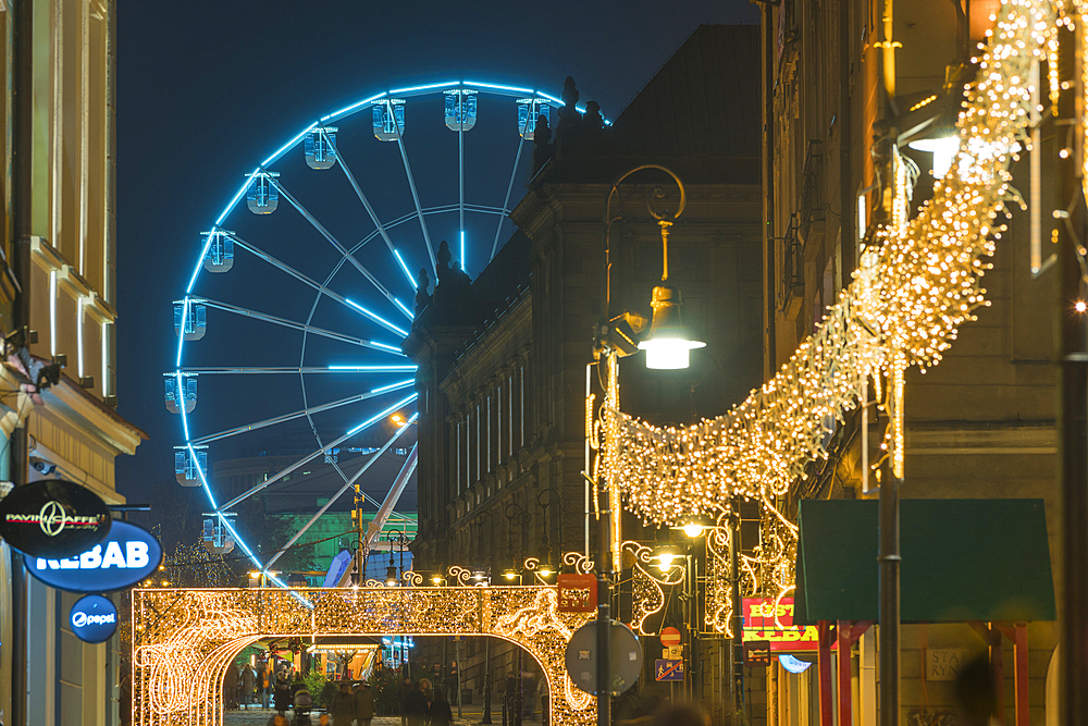 Ferris wheel at Christmas markets at twilight, Poznan, Poland, Europe