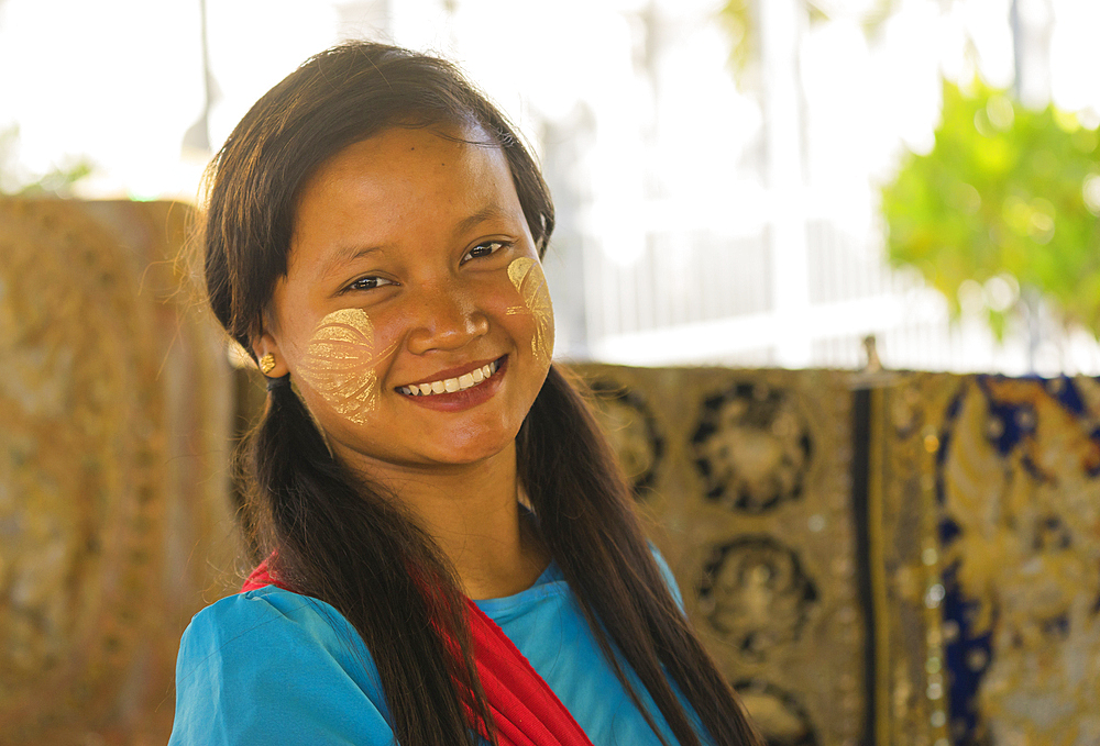 Young Burmese woman with leaves painted on her cheeks with thanaka, Sandamuni Pagoda, Mandalay, Myanmar (Burma), Asia