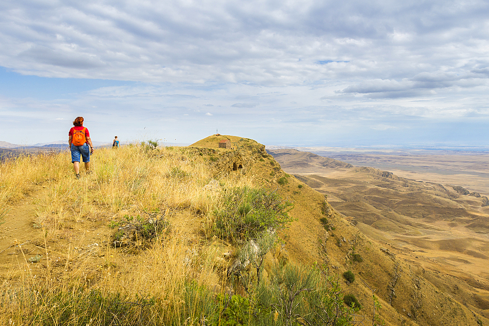 Tourists hiking along the border between Georgia and Azerbaijan near David Gareji Monastery, Udabno, Georgia, Central Asia, Asia