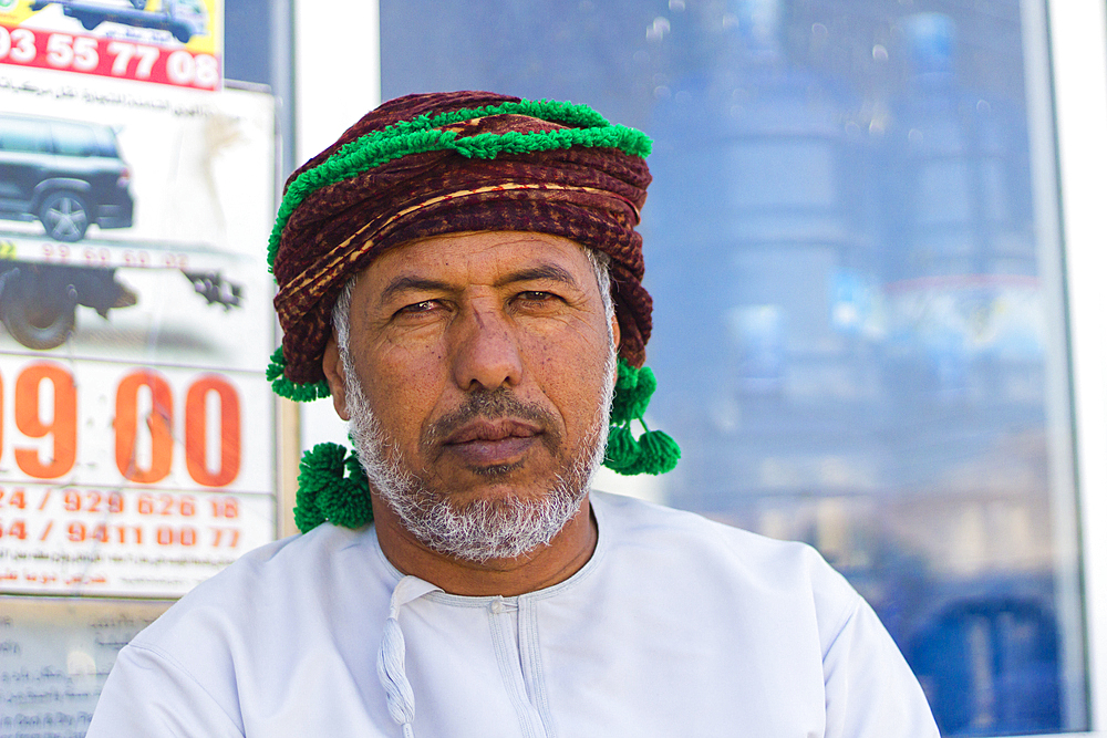 Portrait of Omani man with headwear looking at camera, Hasik, Dhofar Governorate, Oman, Middle East