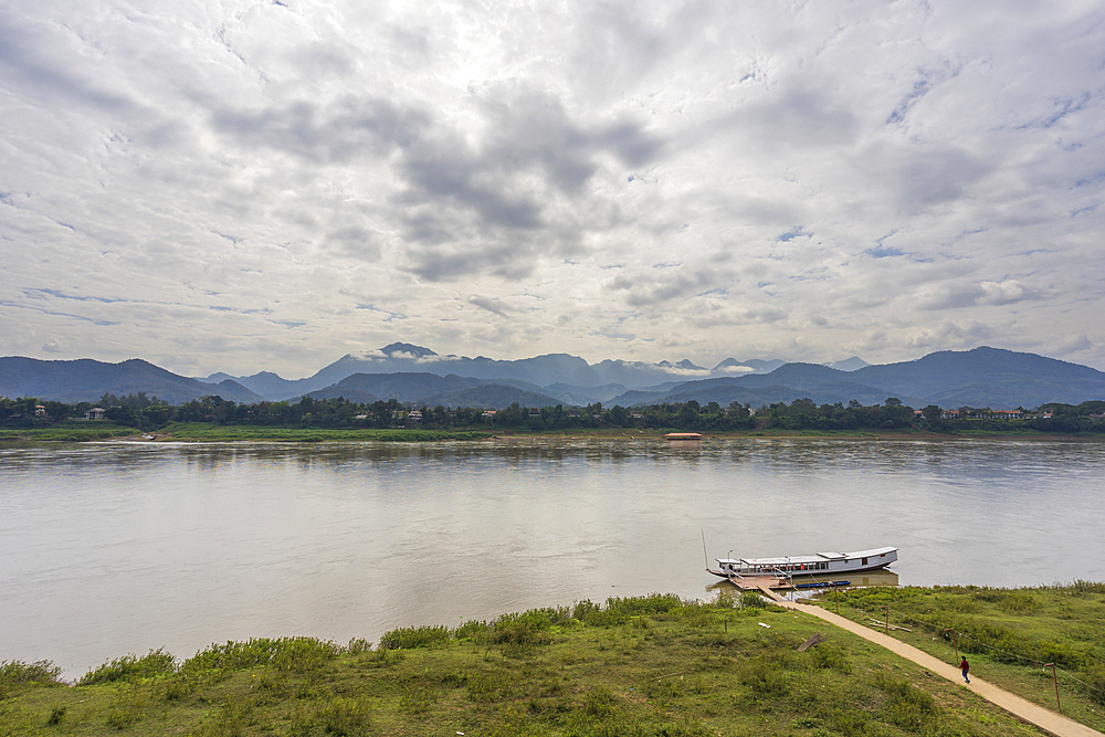 Boat on Mekong River against mountains, Luang Prabang, Laos, Indochina, Southeast Asia, Asia