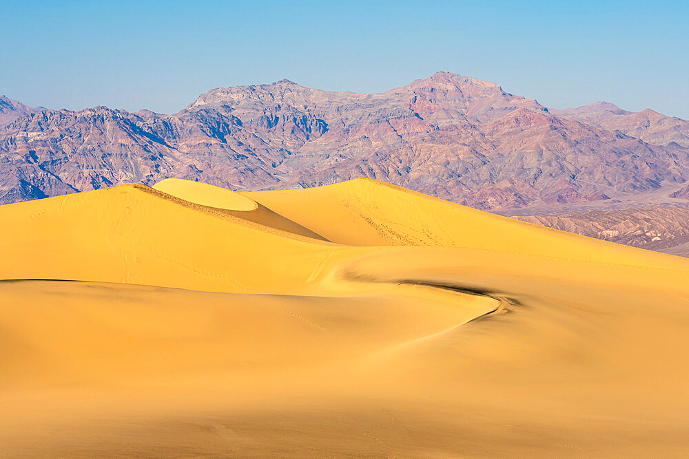 Mesquite Flat Sand Dunes and rocky mountains in desert, Death Valley National Park, California, USA