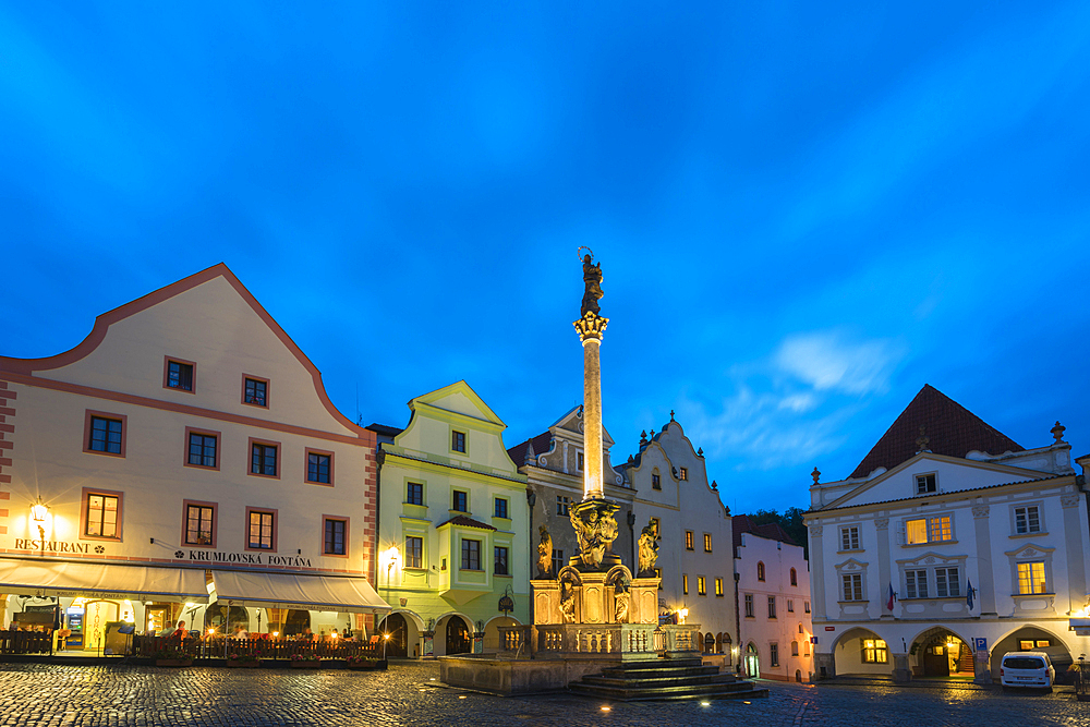 Fountain and Plague Column and traditional houses with gables in background at twilight, Namesti Svornosti Square in historical center, UNESCO, Cesky Krumlov, Czech Republic (Czechia), Europe