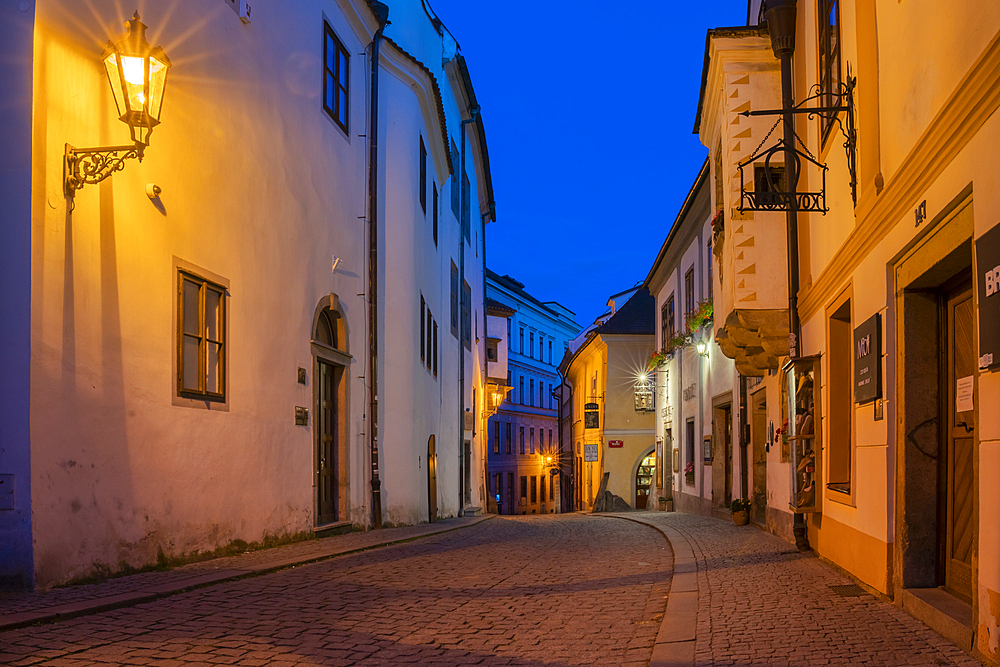 Illuminated street lamp in empty street in historical center at twilight, UNESCO World Heritage Site, Cesky Krumlov, South Bohemian Region, Czech Republic (Czechia), Europe