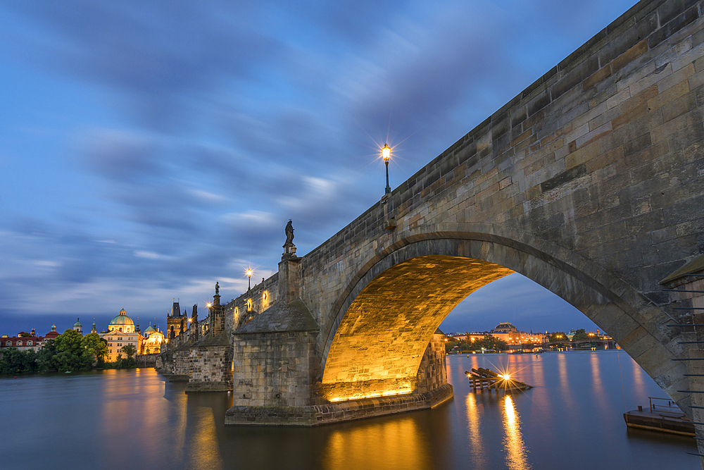 Illuminated arch of Charles Bridge at twilight, UNESCO World Heritage Site, Prague, Bohemia, Czech Republic (Czechia), Europe