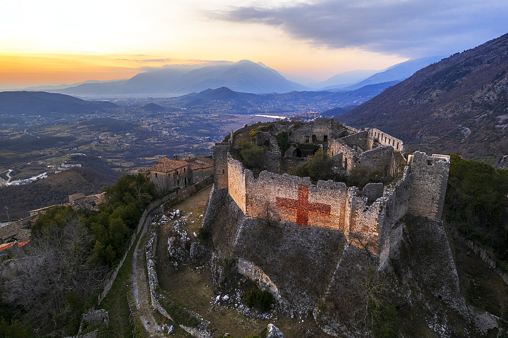 Aerial view of the medieval castle of Vicalvi overlooking the valley with red cross painted on the perimetral wall, at sunset, Vicalvi, Frosinone province, Ciociaria, Latium region, Lazio, Italy, Europe