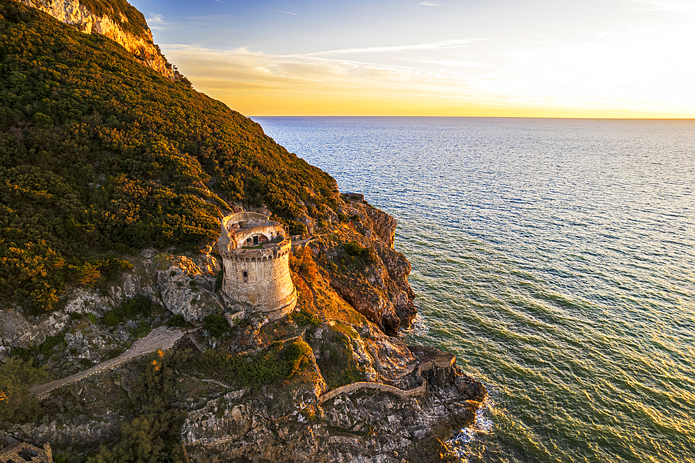 Medieval round tower standing on top of a cliff facing the sea at sunset, aerial shot, Sabaudia, Circeo National Park, Latina province, Latium, Lazio, Italy, Europe